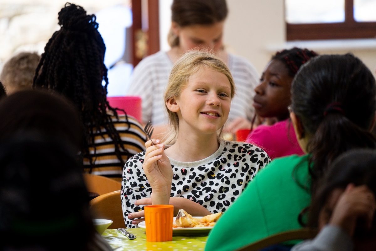 young girl enjoying lunch