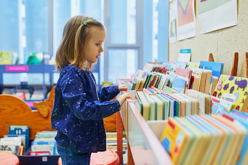 Child looking at books at a children's library