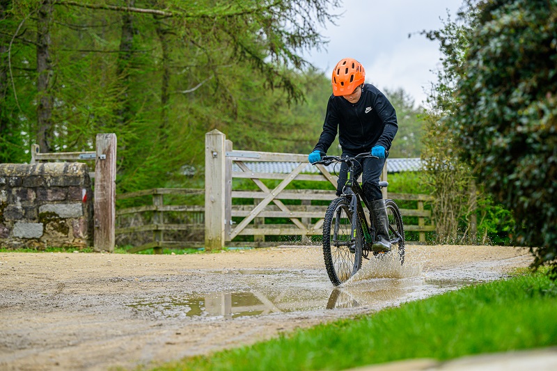 Child riding a bike at Leeds Children's Charity at Lineham Farm